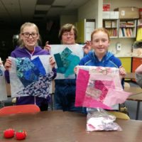 Youth Quilting Classs holding quilt blocks