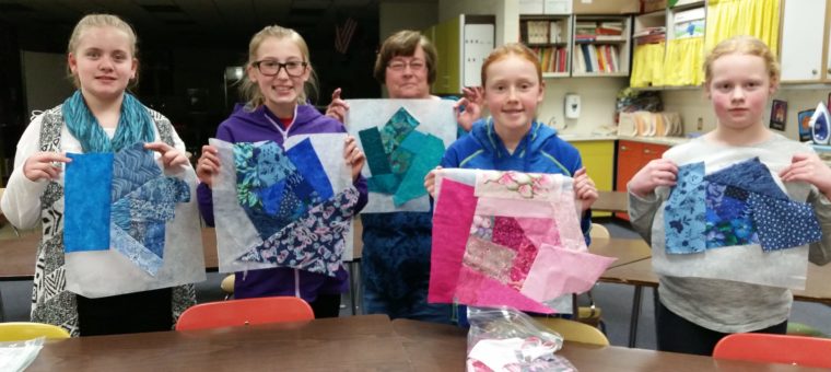 Youth Quilting Classs holding quilt blocks